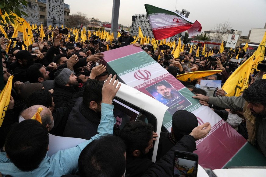 FILE - Iranian mourners carry the flag-draped coffin of Seyed Razi Mousavi, a high ranking Iranian general of the paramilitary Revolutionary Guard, who was killed in an alleged Israeli airstrike in Sy ...