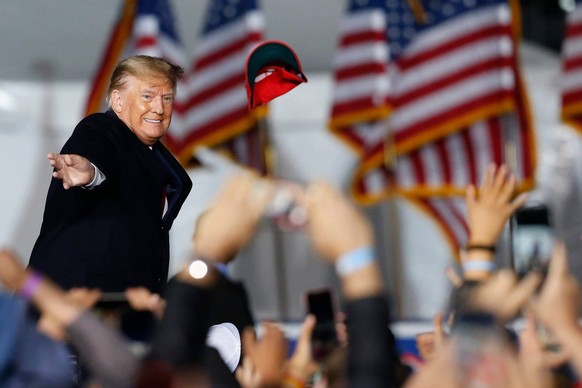 Syndication: Online Athens Former President Donald Trump throws a Make America Great Again hat into the crowd before speaking at a Save America Trump Rally in Commerce, Ga., on Saturday, March 26, 202 ...