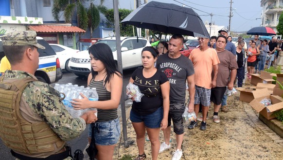 October 9, 2017 - Borinquen, Puerto Rico - U.S. Coast Guard soldiers deliver water and emergency supplies to Puerto Rican residents during relief efforts in the aftermath of Hurricane Maria October 9, ...