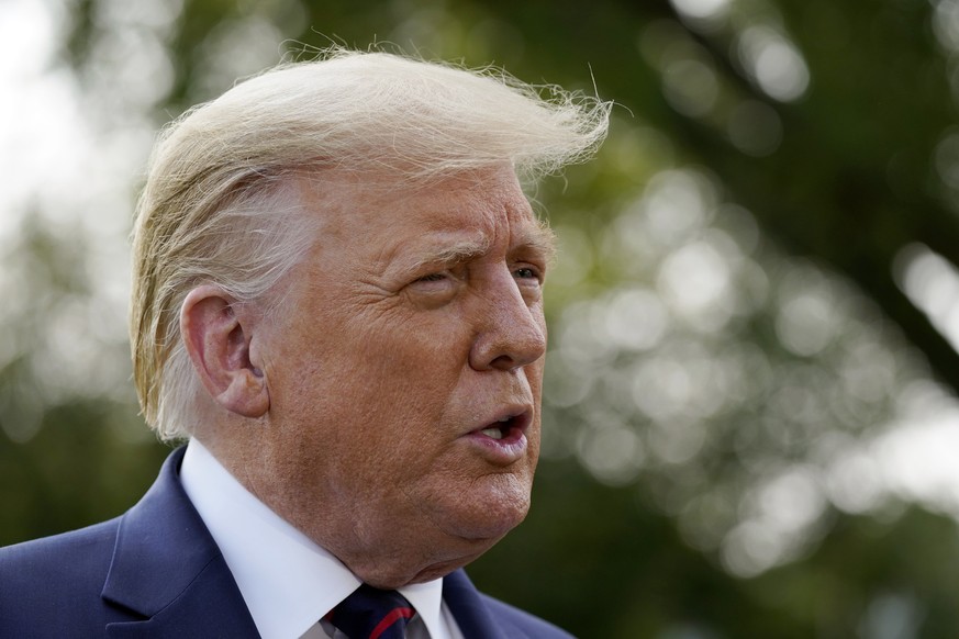 President Donald Trump speaks with reporters as he walks to Marine One on the South Lawn of the White House, Tuesday, Sept. 15, 2020, in Washington. Trump is en route to Philadelphia. (AP Photo/Alex B ...