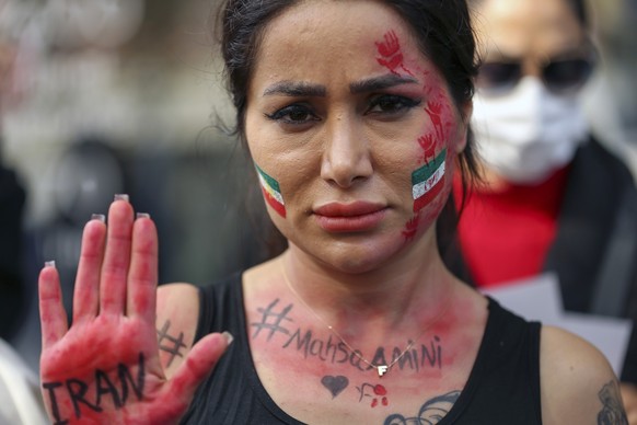 An Iranian woman shows her hand to protest over the death of Mahsa Amini during a demonstration outside the Iranian consulate in Istanbul, Turkey, Monday, Oct. 17, 2022. Amini, a 22-year-old woman who ...