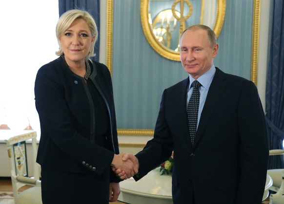 FILE - Russian President Vladimir Putin, right, shakes hands with French far-right presidential candidate Marine Le Pen, in the Kremlin in Moscow, Russia, Friday, March 24, 2017. France is thousands o ...