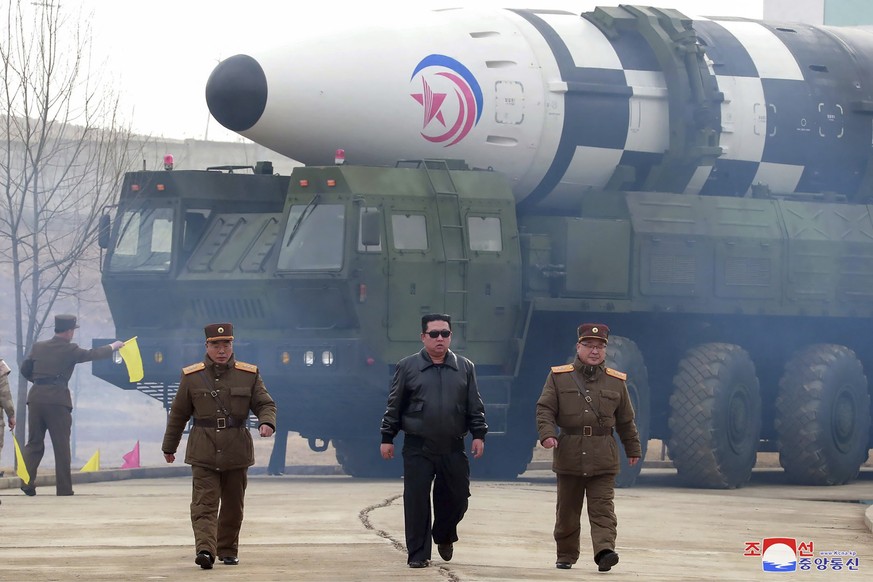 FILE - In this photo distributed by the North Korean government, North Korean leader Kim Jong Un, center, walks around what it says is a Hwasong-17 intercontinental ballistic missile (ICBM) on the lau ...