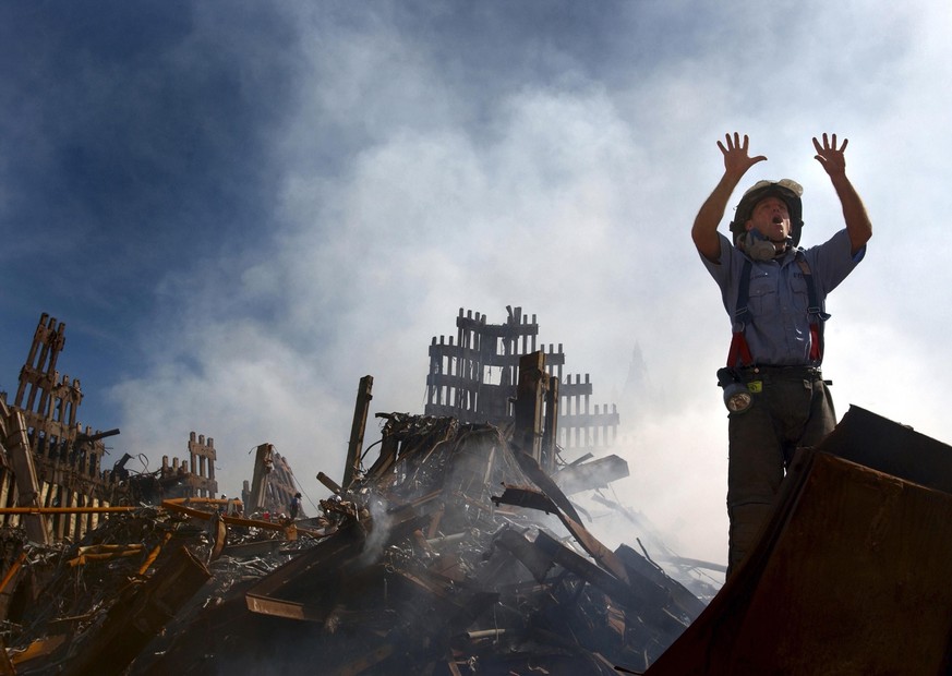 NYC Fireman signals for 10 more rescue workers to come into the rubble of the Ground Zero. Sept. 15, 2001. World Trade Center, New York City, after September 11, 2001 terrorist attacks. U.S. Navy Phot ...