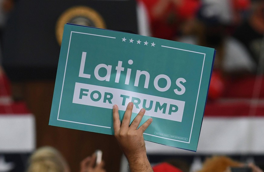 September 24, 2020, Jacksonville, Florida, United States: A supporter of U.S. President, Donald Trump holding a placard saying Latinos for Trump while waiting for the President to arrive at a great Am ...