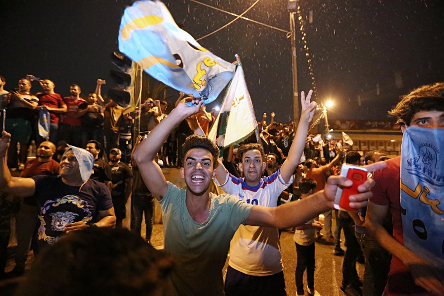 Followers of Shiite cleric Muqtada al-Sadr celebrate in Tahrir Square, Baghdad, Iraq, early Monday, May 14, 2018. Iraq&#039;s electoral commission announces influential Shiite cleric Muqtada al-Sadr i ...