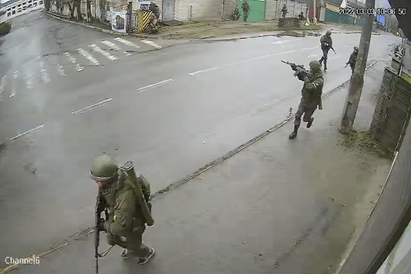 In this image from surveillance video, Russian troops take over Yablunska Street in Bucha, Ukraine on March 3, 2022, where they set up a headquarters during their month-long occupation. Police recover ...