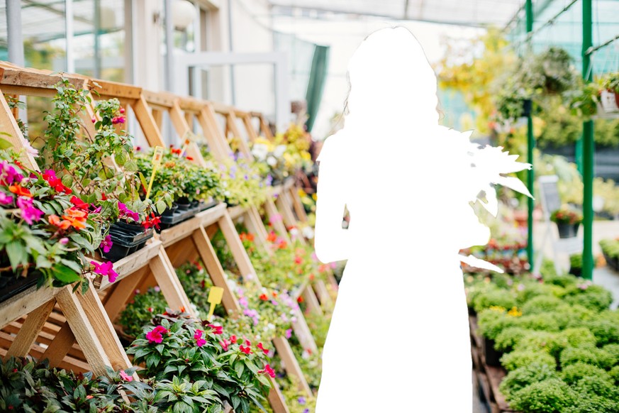 Attractive young woman in a flower center.