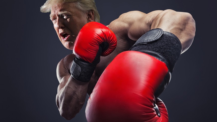 Boxing concept. Boxer with an aggressive look in red boxing gloves before a fight against a black background