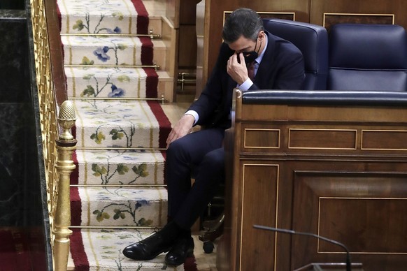 File - Spain&#039;s Prime Minister Pedro Sanchez listens to a speech by Vox party leader Santiago Abascal during a parliamentary session in Madrid, Spain, Wednesday Oct. 21, 2020. Spain&#039;s Sociali ...