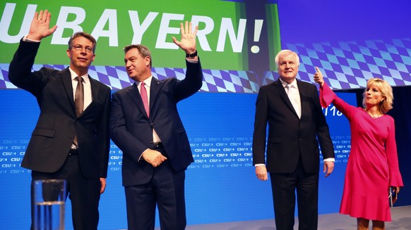 Bavarian State Governor Markus Soeder, second left, waves as he arrives besides German Interior Minister Horst Seehofer, second right, Secretary General Markus Blume, left, and Deputy Secretary Genera ...