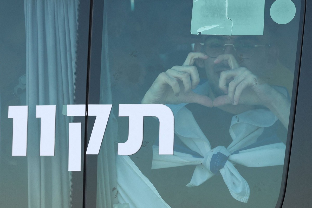 Rom Braslavski, a released hostage who was kidnapped during the deadly October 7, 2023 attack by Hamas and taken to Gaza, gestures from a vehicle, amid a ceasefire between Israel and Hamas in Gaza, in ...