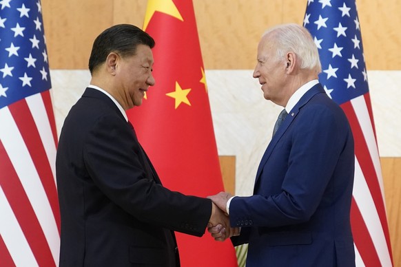 FILE - U.S. President Joe Biden, right, and Chinese President Xi Jinping shake hands before their meeting on the sidelines of the G20 summit meeting, Nov. 14, 2022, in Nusa Dua, in Bali, Indonesia. (A ...