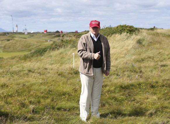 FILE - In this July 30, 2015, then-presidential contender Donald Trump gestures to the media on the 17th fairway on the first day of the Women&#039;s British Open golf championship on the Turnberry go ...