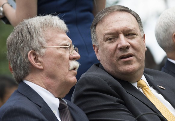 National security adviser John Bolton (L) and Secretary of State Mike Pompeo talk prior to a joint press conference between President Donald J. Trump and Japanese Prime Minister Shinzo Abe, at the Whi ...