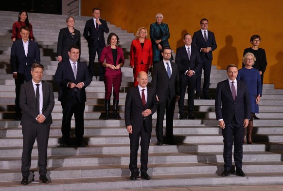 BERLIN, GERMANY - DECEMBER 08: Members of the new German government cabinet, including new Chancellor Olaf Scholz (C), pose for a photo after convening for the first time at the Chancellery on Decembe ...