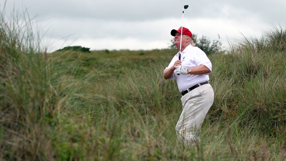ABERDEEN, SCOTLAND - JULY 10: Donald Trump plays a round of golf after the opening of The Trump International Golf Links Course on July 10, 2012 in Balmedie, Scotland. The controversial £100m course o ...