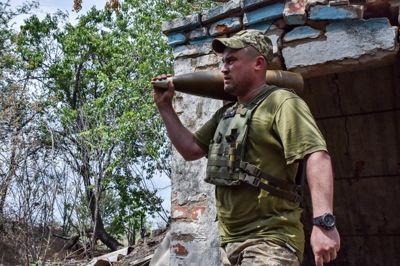 June 8, 2024, Orikhiv, Zaporizhzhia, Ukraine: A Ukrainian soldier of 65th Separate Mechanized brigade carry a shell for a self-propelled artillery system at the front line in Zaporizhzhia region. West ...