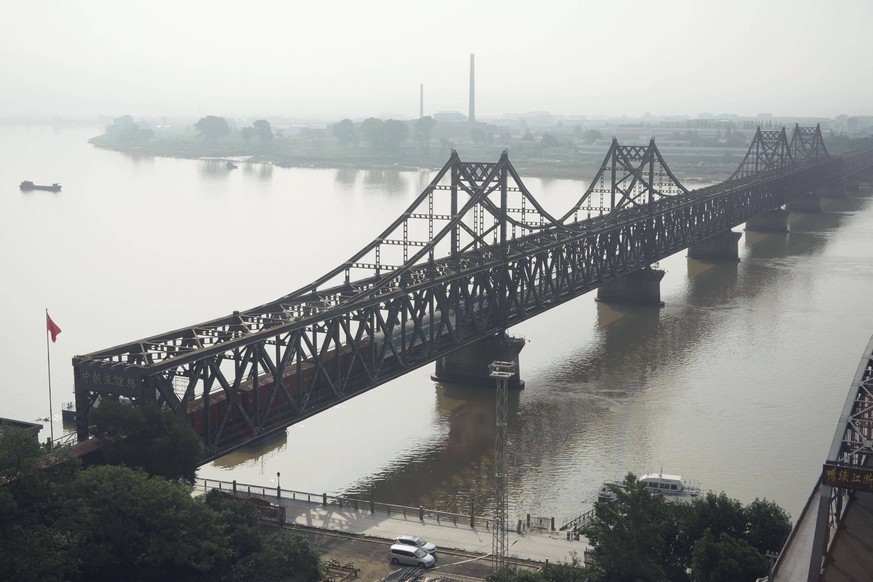 Aftermath of heavy rain in N. Korea Photo taken from Dandong, a Chinese border city near the Yalu River, shows a freight train heading to North Korea s Sinuiju on the Sino-Korean Friendship Bridge on  ...