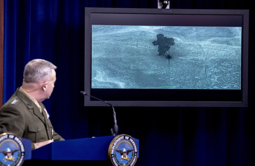 Video of the Abu Bakr al-Baghdadi raid is displayed as U.S. Central Command Commander Marine Gen. Kenneth McKenzie speaks, Wednesday, Oct. 30, 2019, at a joint press briefing at the Pentagon in Washin ...