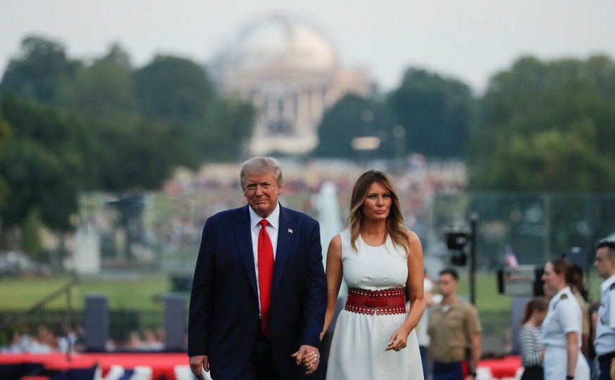 U.S. President Donald Trump and first lady Melania Trump walk back into the White House after hosting a 4th of July &quot;Salute to America&quot; to celebrate the U.S. Independence Day holiday on the  ...
