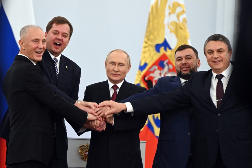 From left, Moscow-appointed head of Kherson Region Vladimir Saldo, Moscow-appointed head of Zaporizhzhia region Yevgeny Balitsky, Russian President Vladimir Putin, center, Denis Pushilin, leader of se ...