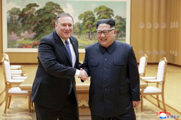 FILE - In this May 9, 2018, file photo provided by the North Korean government, U.S. Secretary of State Mike Pompeo, left, poses with North Korean leader Kim Jong Un for a photo during a meeting at Wo ...