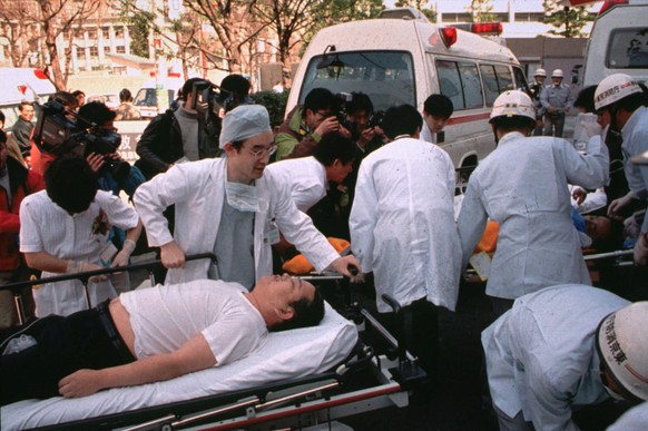 FILE - In this March 20, 1995 file photo, subway passengers affected by sarin nerve gas in the central Tokyo subway trains are carried into St. Luke's International Hospital in Tokyo. Tuesday, March 2 ...