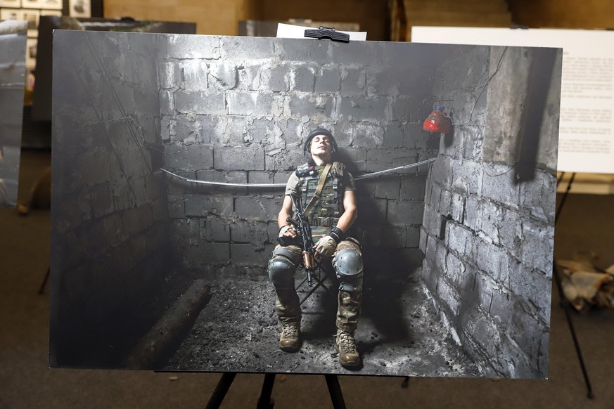 DNIPRO, UKRAINE - DECEMBER 02, 2021 - Picture displayed during the exhibition featuring everyday life of servicemen and volunteer defenders in the front line of eastern Ukraine by a Romanian photojour ...