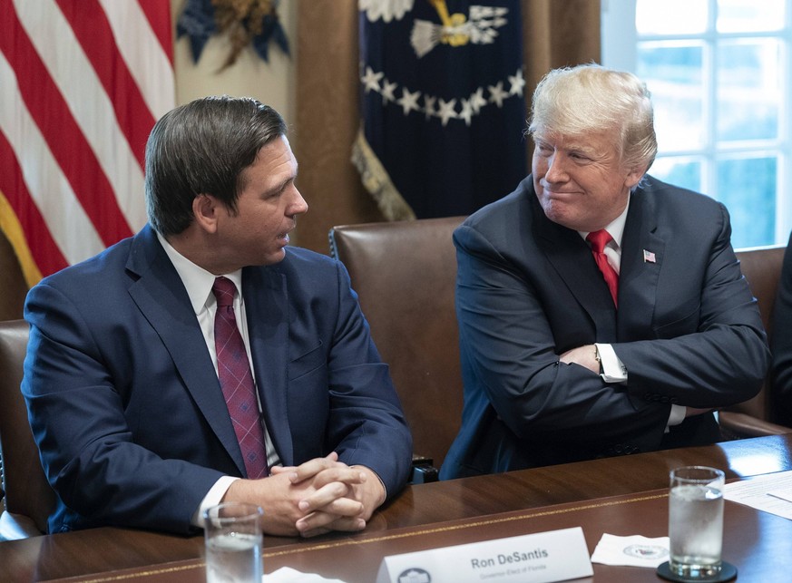 United States President Donald J. Trump listens to Governor- elect Ron DeSantis of Florida speak during a meeting with governors-elect at the White House in Washington, DC on December 13, 2018. PUBLIC ...