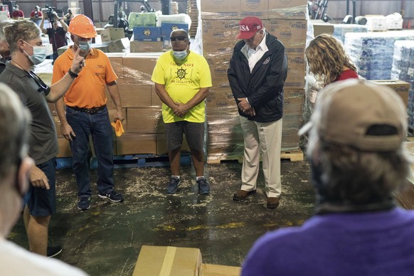 August 29, 2020, Lake Charles, LA, United States of America: U.S. President Donald Trump joins in a prayer during a visit to the Cajun Navy Relief Center warehouse for Hurricane Laura relief assistanc ...