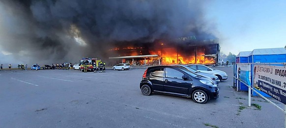 June 27, 2022, Kremenchuk, Ukraine: Firefighters work to put out the fire in a mall hit by a Russian missile strike at 3:50 Pm on a Monday afternoon, in the eastern Ukrainian city of Kremenchuk. Ukrai ...