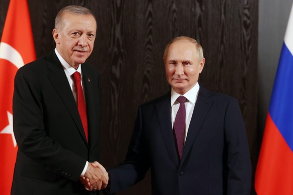 FILE - Russian President Vladimir Putin, right, shakes hands with Turkey&#039;s President Recep Tayyip Erdogan prior to their talks on the sidelines of the Shanghai Cooperation Organisation (SCO) summ ...
