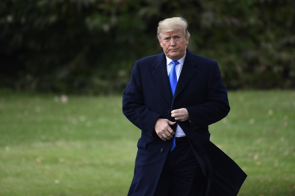 President Donald Trump walks from the Oval Office to speak with reporters at the White House in Washington, Friday, Oct. 26, 2018, before boarding Marine One for the short trip to Andrews Air Force Ba ...