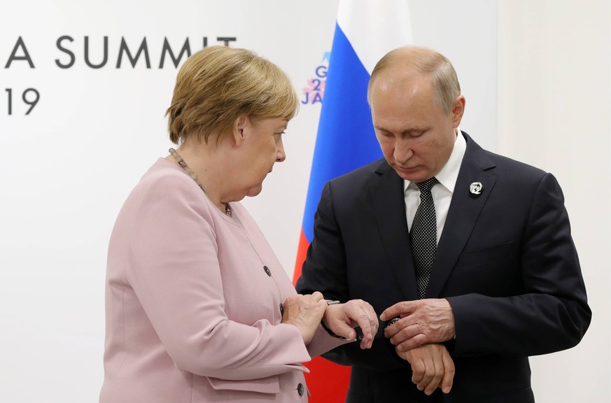 OSAKA, JAPAN JUNE 29, 2019: Germany s Chancellor Angela Merkel L and Russia s President Vladimir Putin during a meeting on the sidelines of a G20 leaders summit, at the INTEX Osaka International Exhib ...