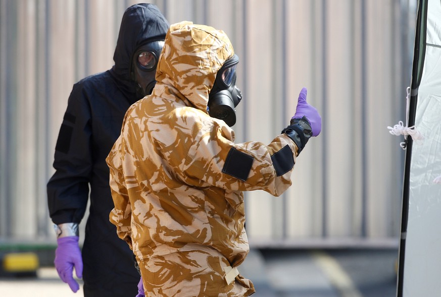 FILE PHOTO: Forensic investigators, wearing protective suits, emerge from the rear of John Baker House, after it was confirmed that two people had been poisoned with the nerve-agent Novichok, in Amesb ...