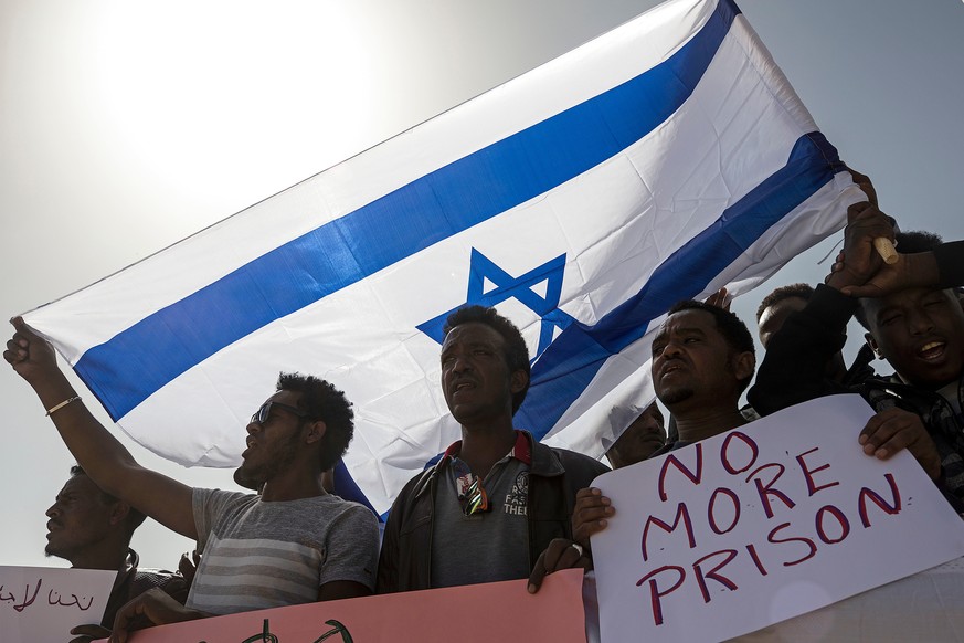 FILE - In this Feb. 22, 2018 file photo, asylum seekers march during a protest outside Israeli Prison Saharonim, in the Negev desert, southern Israel. Prime Minister Benjamin Netanyahu's office said M ...