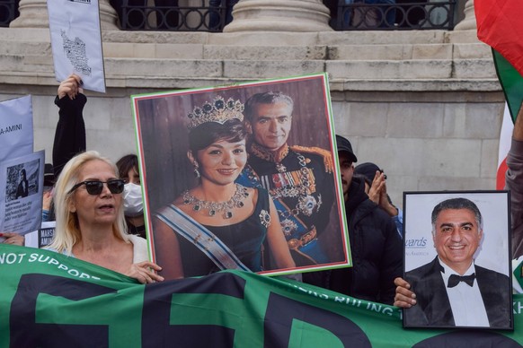 September 24, 2022, London, England, United Kingdom: A protester holds a picture of the late former Shah of Iran, Mohammad Reza Pahlavi, and Consort Farah Pahlavi. Thousands of Iranians and other prot ...