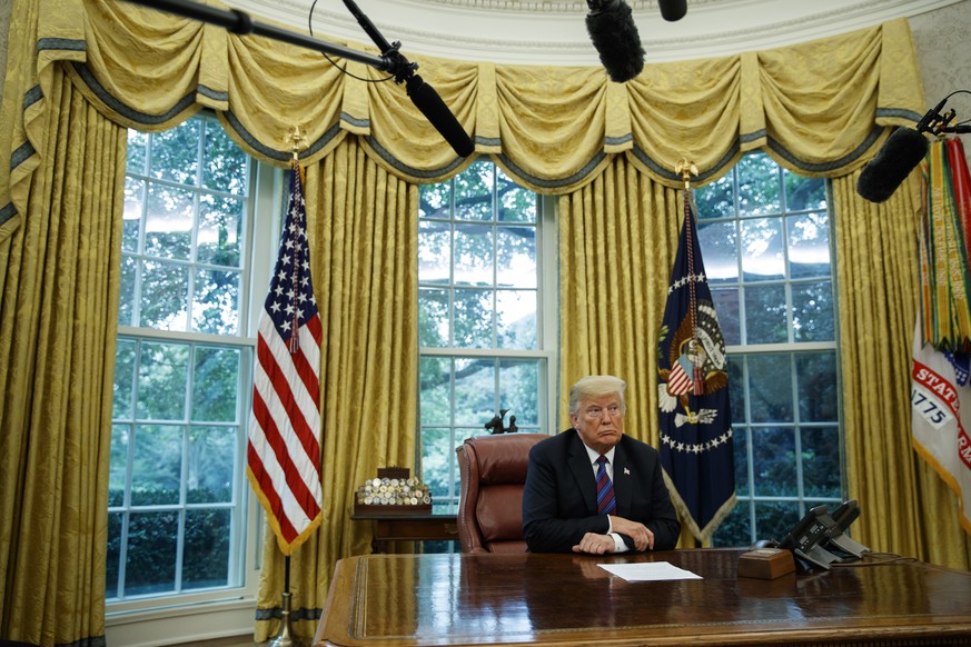 In this Aug. 27, 2018, photo, President Donald Trump listens during a phone call with Mexican President Enrique Pena Nieto about a trade agreement between the United States and Mexico, in the Oval Off ...