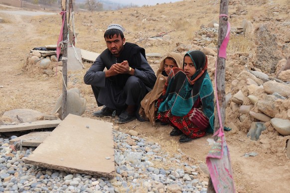 201123 -- TIRINKOT, Nov. 23, 2020 -- The relatives of victims killed by Australian troops during their mission pray at a tomb in Tirinkot, capital of Uruzgan, Afghanistan, Nov. 22, 2020. TO GO WITH Ro ...