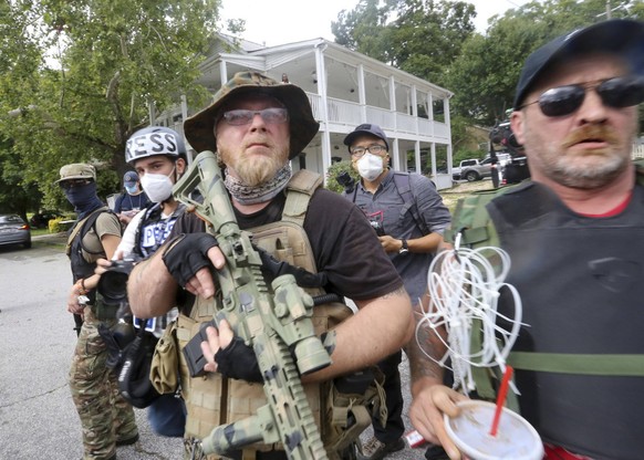 August 15, 2020, Stone Mountain, GA, USA: Counter protesters face off with protesters as several far-right groups, including militias and white supremacists, rally Saturday, Aug. 15, 2020, in Stone Mo ...