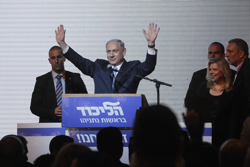 Israeli Prime Minister and Likud Party leader Benjamin Netanyahu (2nd L) waves to supporters at Likud Party campaign headquarters in Tel Aviv, Israel, on March 18, 2015. Incumbent Israeli Prime Minist ...