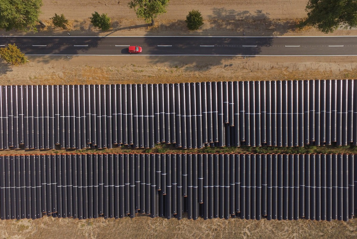 GOLSSEN, GERMANY - AUGUST 29: In this aerial view a car drives past steel pipes that lie stacked ahead of construction of the Eugal natural gas pipeline at Rietzneuendorf-Staakow on August 29, 2018 ne ...