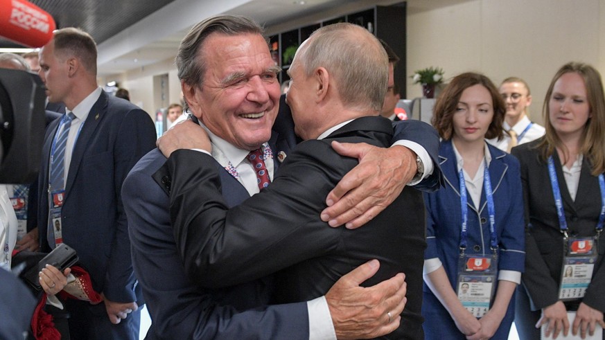 MOSCOW, RUSSIA - JUNE 14, 2018: Russia's President Vladimir Putin (R) hugs Gerhard Schroeder, Chairman of the Shareholders Committee with Nord Stream 2 AG and former German chancellor, at the opening  ...