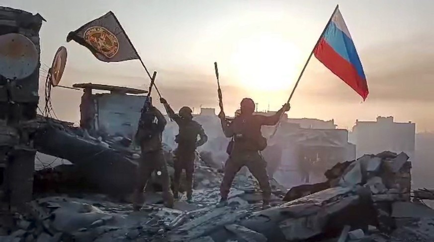 FILE - In this image from video provided by Prigozhin Press Service on Saturday, May 20, 2023, Yevgeny Prigozhin&#039;s Wagner Group military company members wave a Russian national and Wagner flag at ...