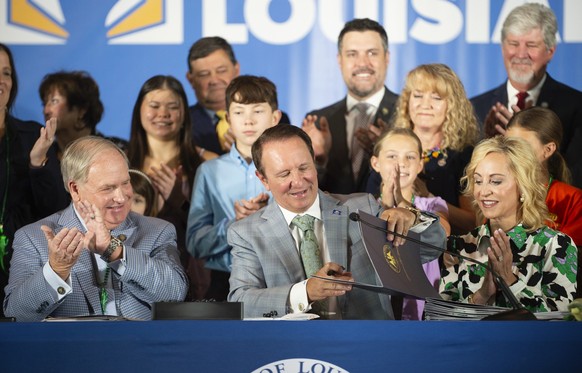 Louisiana Gov. Jeff Landry signs bills related to his education plan on Wednesday, June 19, 2024, at Our Lady of Fatima Catholic School in Lafayette, La. Louisiana has become the first state to requir ...