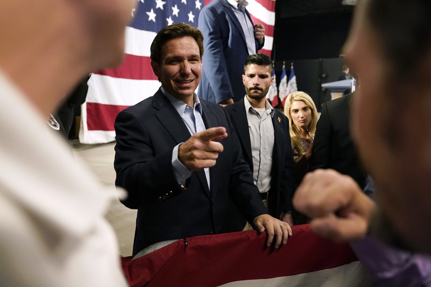 Republican presidential candidate Florida Gov. Ron DeSantis greets audience members during a campaign event, Tuesday, May 30, 2023, in Clive, Iowa. (AP Photo/Charlie Neibergall)