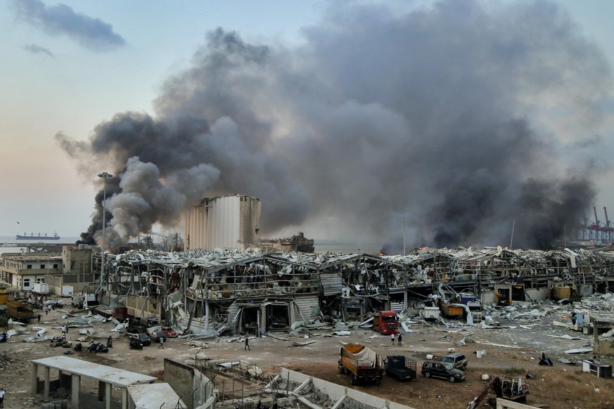 dpatopbilder - 08.01.2020, Libanon, Beirut: Rauch steigt nach einer Explosion über einem Gebäude am Hafen auf. Eine schwere Explosion erschüttert die Innenstadt von Beirut und beschädigte Gebäude. Es  ...