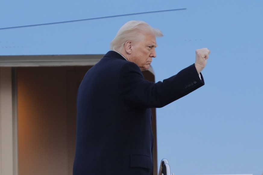 President Donald Trump gestures from the stairs of Air Force One at Joint Base Andrews, Md., Friday, March 7, 2025. (AP Photo/Luis M. Alvarez)