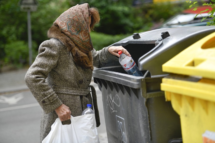 Gestelltes Symbolfoto, Altersarmut, Seniorin, Flaschensammeln, Mülleimer *** Symbol photo presented poverty in old age senior woman bottle collecting garbage can